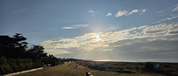 The Greensward looking east on a summer morning, with the sun breaking through cloud over the sea