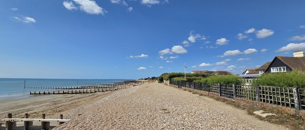 Looking west along the Greensward from the eastern end, with the groynes running out into the sea