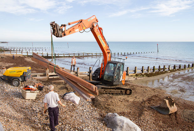 Repair work under way on a timber groyne on the foreshore